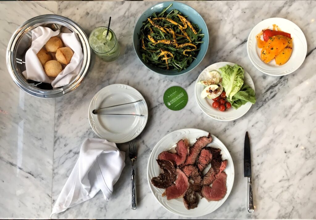 platillos con carne y pan ensaladas pimientos limonada y cubiertos